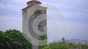 A handheld shot of a clocktower in the ruins of the Bar old city or Stari Grad. A destroyed ancient settlement close to