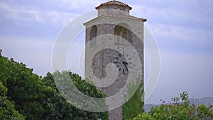 A handheld shot of a clocktower in the ruins of the Bar old city or Stari Grad. A destroyed ancient settlement close to