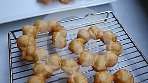 Handheld slow motion shot of homemade deep fried pon de ring mochi donuts