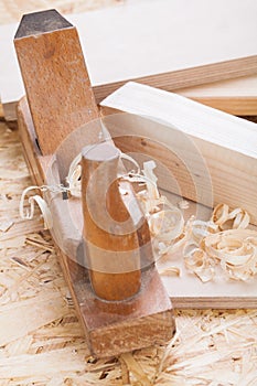 Handheld wood plane with wood shavings