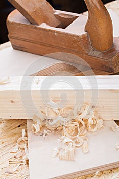 Handheld wood plane with wood shavings