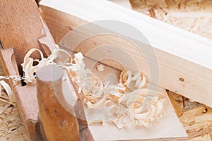 Handheld wood plane with wood shavings