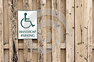 Handicap Parking sign on a wood slat fence