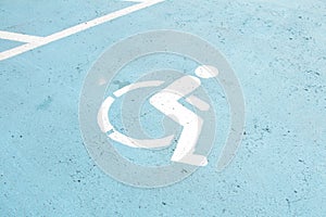 handicap symbol on cement pavement concrete with blue background painted in park 169 p 17