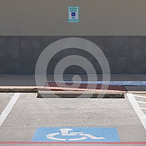 Handicap symbols on asphalt road, parking place reserved for disabled person or people