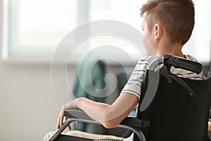 Handicapped boy in wheelchair at home