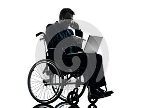 Handicapped business man computing laptop computer in wheelchai