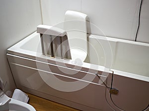 Handicapped disabled access bathroom bathtub with electric handles