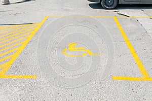 Handicapped disabled icon sign on parking lot or space area in car park in the city street