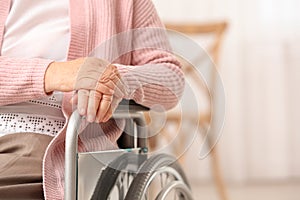 Handicapped elderly woman in nursing home, closeup. Assisting senior generation