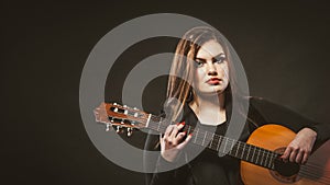 Handicapped girl holding guitar