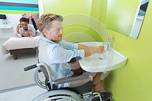 Handicapped man using hotel facilities