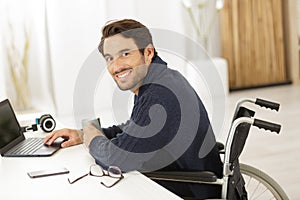 Handicapped man using laptop at home