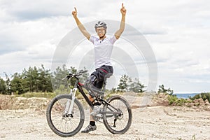 Handicapped mountain bike raising up arms