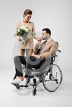 handicapped muslim man kissing hand of