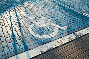 Handicapped parking bay. Reserved parking sign for disabled spaces disabled blue parking sign painted on dark asphalt