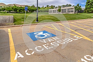 Handicapped parking lot with painted handicap symbol and Van Accessible sign