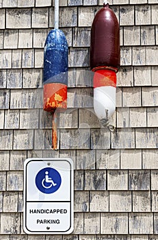 Handicapped Parking sign in Maine with lobster buoys on wall