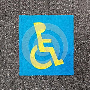 Handicapped parking sign paint on asphalt