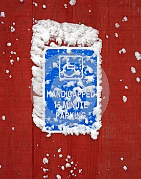 Handicapped parking sign with snow