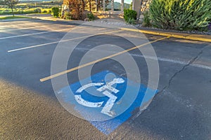 Handicapped parking space at a parking lot outside a building on a sunny day