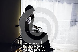 Handicapped Sad Man sitting on wheelchair and empty room