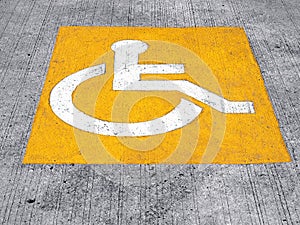 handicapped sign on parking lot floor, universal symbol for representing equal accessibility and inclusion for disabled