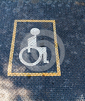 Handicapped sign on Rusty Surface of old Checkered Plate