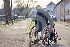 Handicapped woman manoeuvring her wheelchair