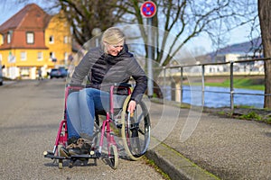 Handicapped woman manoeuvring her wheelchair