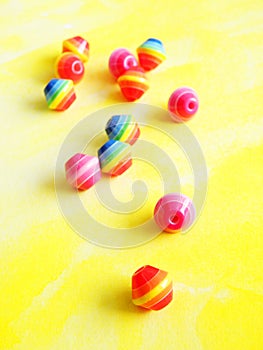 Handicraft beads on yellow background