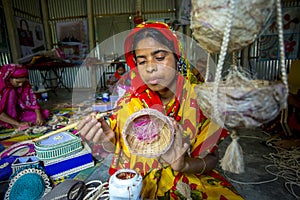 Handicraft maker women are making on a showpiece bird nests using on pineapple fiber at Madhupur,
