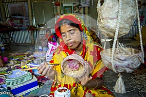 Handicraft maker women are making on a showpiece bird nests using on pineapple fiber at Madhupur,