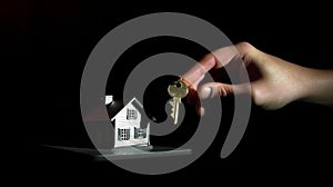 Handing over house keys on dark background