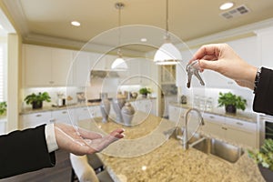 Handing Over New House Keys Inside Beautiful Kitchen