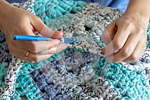 Handiwork. Knitting. Handmade. Girl crocheting floor Mat