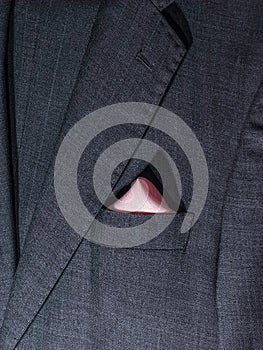 Handkerchief in a gray suit pocket.Beautifully clothed pubs in a robe pocket.