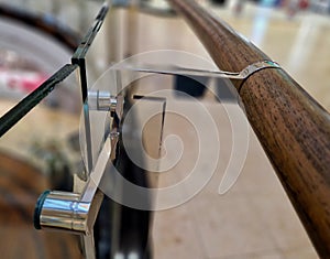 handle on the glass railing is stylishly simple, the wooden bars on the