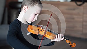 Handle hold violin. Little boy carrying violin. Young boy playing violin, talented violin player