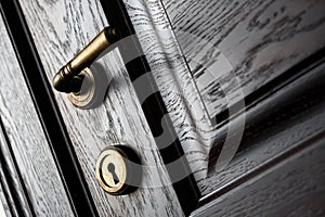 Handle and keyhole  on a wooden door in beautiful lighting photo