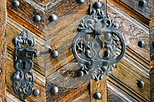 Handle and lock in iron on old wooden door