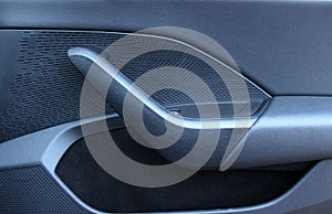 Handle and pocket on the inner panel of a car door