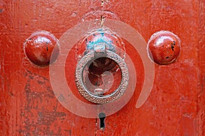 Handle ring on an old red painted door