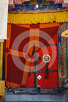 Handle to old temple door decorated with plaited tassel. Thiksey Buddhist monastery in Ladakh, India