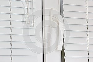 Handle white plastic office windows with shutters