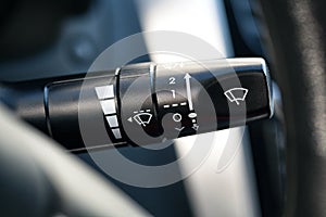 The handle of the windshield wiper in the car