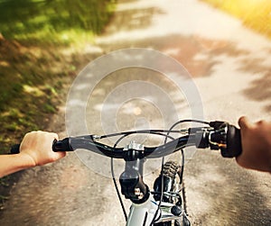 Handlebar with child hands close up image