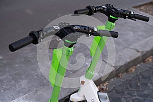 Handlebar with QR code of two parked Electric Kick Scooters in Rome