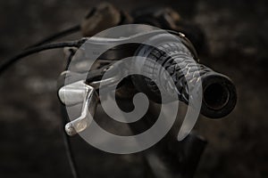 The handlebars of a bike in the parking.