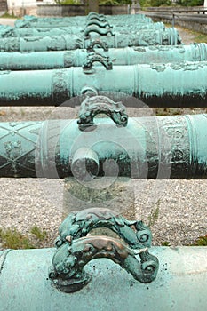 Handles on antique ornamented cannon barrels